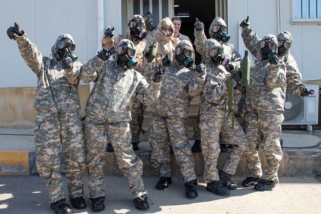 U.S. Army Soldiers, with 655 Regional Support Group, 316 Sustainment Command (Expeditionary), 377 Theater Sustainment Command, pose for a photo alongside the Jordan Armed Forces-Arab Army Quick Reaction Force Female Engagement Team and Canadian Armed Forces during a practical exercise at a Chemical, Biological, Radiological and Nuclear. Pubilc domain image from the US Government NARA & DVIDS Public Domain Archive
