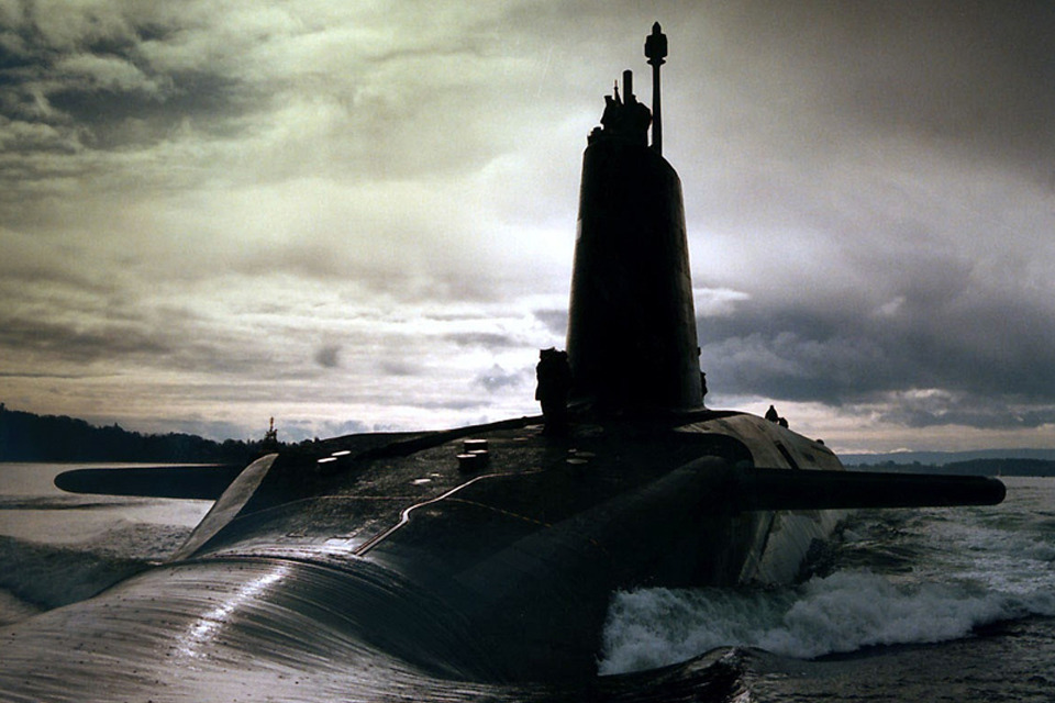 HMS Vigilant, the third of the Royal Navy's Vanguard Class nuclear-powered ballistic missile submarines. Dramtically backlit against a cloudy sky