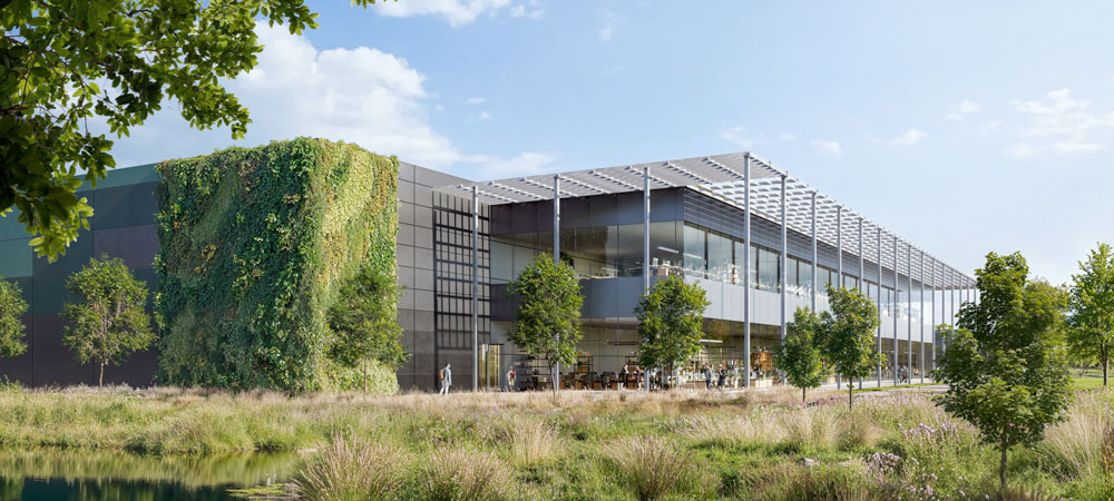 A visualisation of a data centre proposed for land near South Mimms in Hertsmere, UK. A modern, two-story industrial building is surrounding by planting.